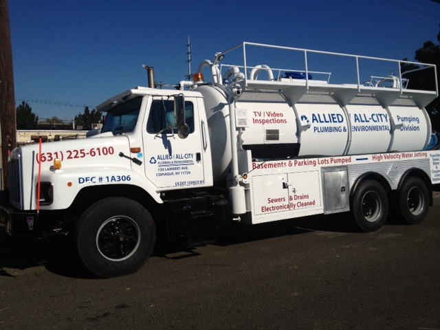 A large white Allied All-City Environmental truck is parked on a street. The truck advertises plumbing and pumping services, including basement and parking lot pumping, TV video inspections, and sewer cleaning.